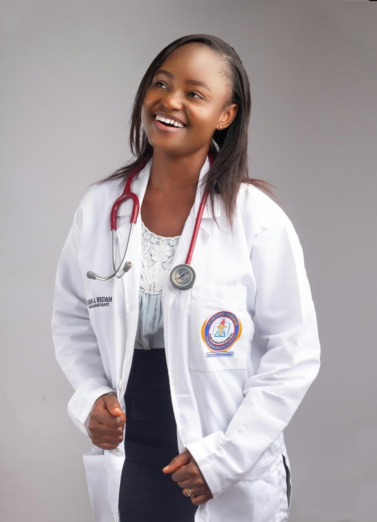 Smiling woman doctor in a white coat with a stethoscope in Accra