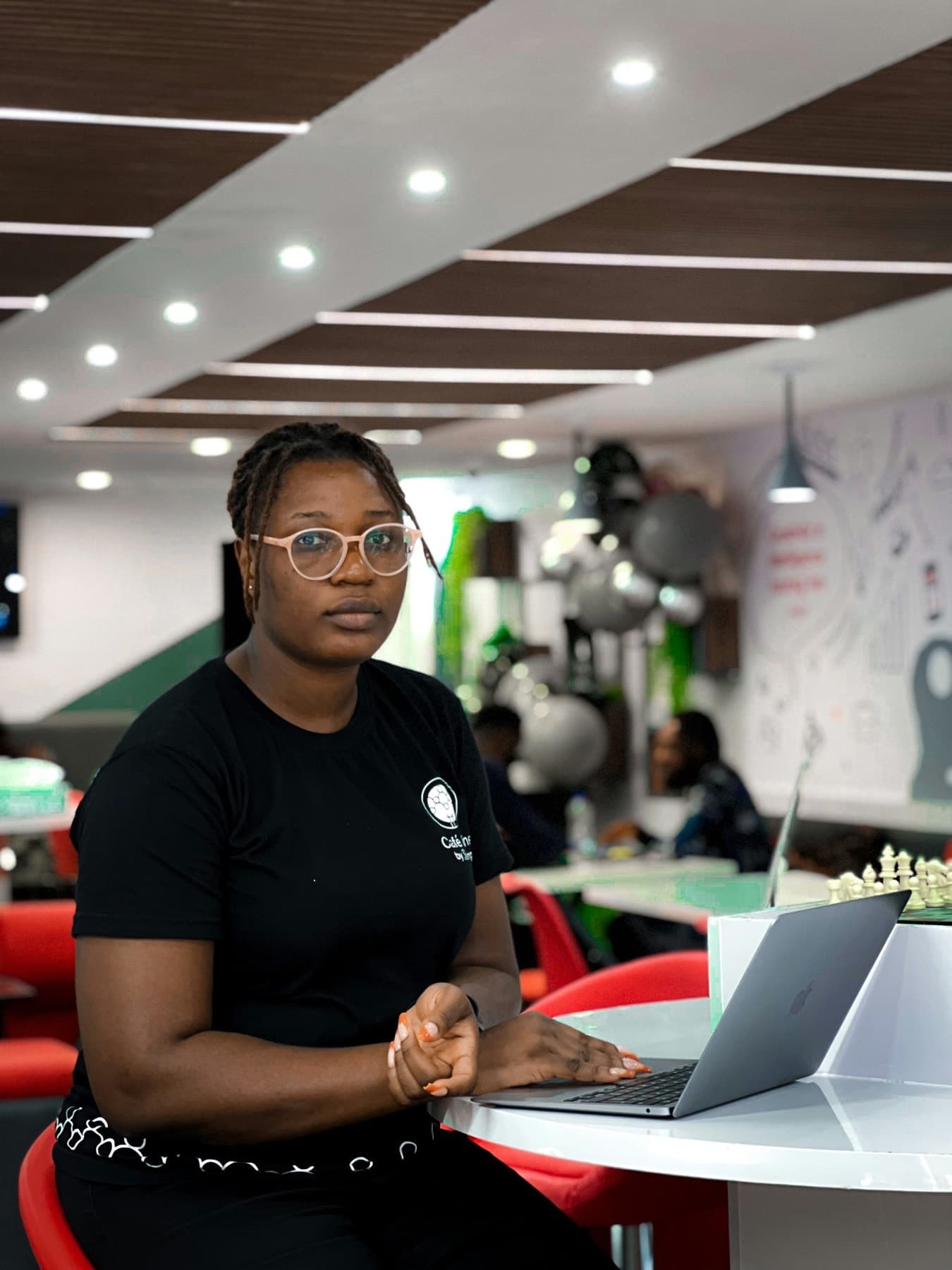Woman working at a laptop in a modern Lagos office