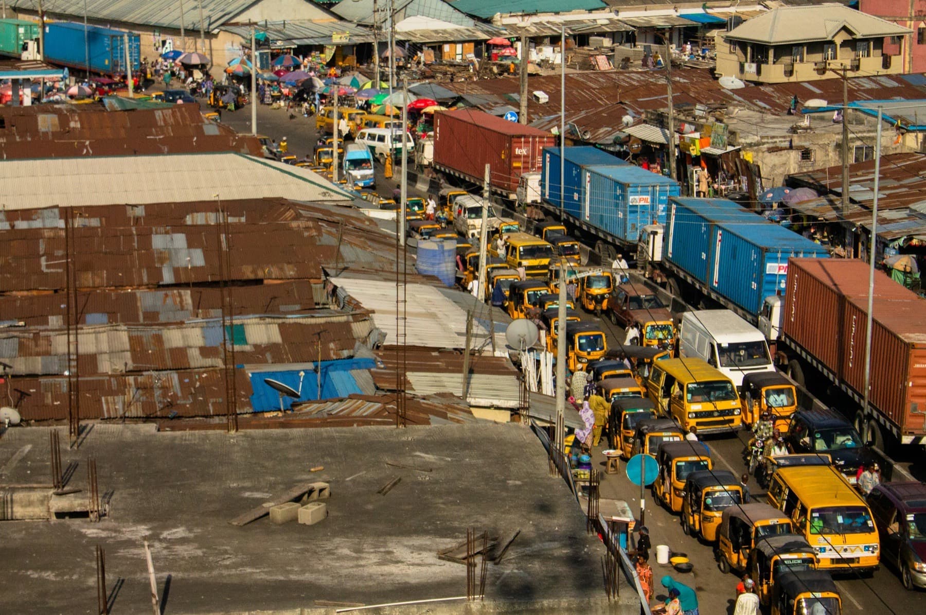 Elevated view of container trucks and buses queued along a road in Apapa, Lagos
